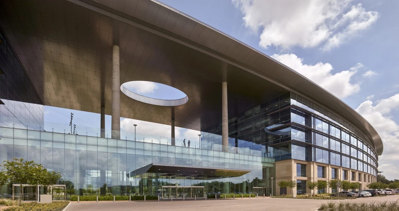 Toyota North American Headquarters campus building in Plano, Texas, with a sweeping curved roof and glass facade
